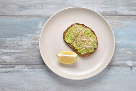 Healthy avocado sandwich , dark bread. Spicy rye toast