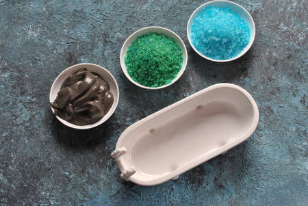 Spa and body care products. Colorful aromatic bath Dead Sea Salt and black Dead Sea Mud. Natural ingredients for homemade body scrub. Dead Sea cosmetics. Beauty skin care. Spa treatmentの写真素材