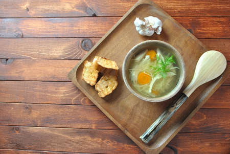 Chicken soup with noodles and vegetables in bowl on wooden background homemade healthy meal