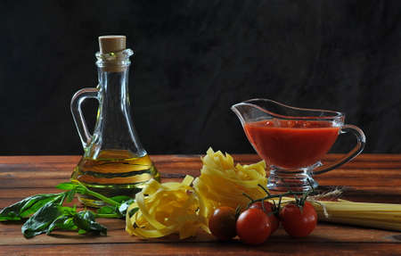 Food ingredients for Italian pasta with tomatoes, basil, tomato sauce and olive oil. Italian food conceptの写真素材