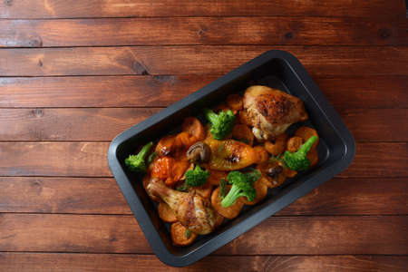 Homemade baked sweet potato slices with fried chicken, broccoli, sweet yellow pepper . Tasty colorful dinnerの写真素材