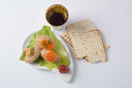 Passover traditional Jewish food- gefilte fish with carrots, lettuce, horse radish and matzah. Passover celebration conceptの写真素材
