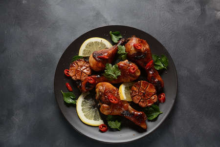 Grilled chicken legs with spices, parsley, garlic and lemon. Barbecue chicken conceptの写真素材