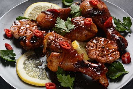 Grilled chicken legs with spices, parsley, garlic and lemon. Barbecue chicken conceptの写真素材