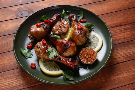 Grilled chicken legs with spices, parsley, garlic and lemon. Barbecue chicken conceptの写真素材