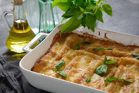 Cannelloni pasta stuffed with spinach, mushrooms,ricotta and sauce bechamel. Italian cuisine. Traditional food for Shavuot Jewish holidayの写真素材