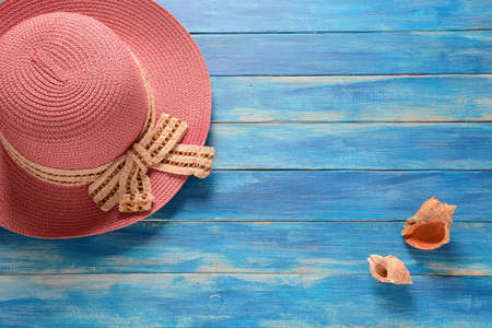 Top view of blue planks marine pier near the beach. Frame composition with summer accessories....