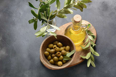 Extra virgin Olive oil , olive branch and olives on a dark backgroundの写真素材