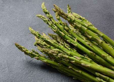 Seasonal product fresh green  Asparagus on dark backgroundの写真素材