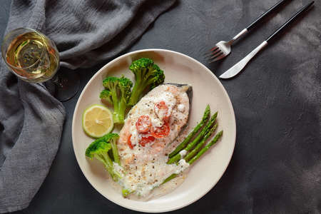 Creamy Garlic Butter Tuscan Salmon oven baked   in a delicious lemon cream sauce with asparagus,...