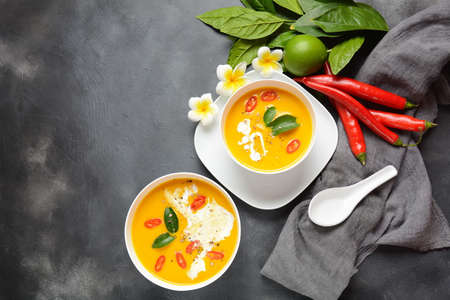 Thai spicy pumpkin and coconut milk soup with kaffir lime leaves , red chilli and galangal roots...