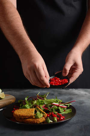 Broccoli schnitzel served with pomegranate salad. Healthy vegan food .