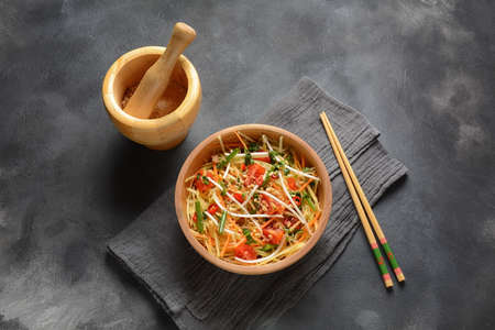 Som Tam -Thai green papaya salad) with green beans, tomatoes, peanuts.  Thai street food . Healthy vegan foodの写真素材