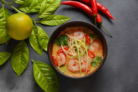 Laksa Soup â a Malaysian  Coconut Curry  Soup with shrimps over rice noodles topped with fresh bean spouts,cucumber, lime, red chili pepper and cilantroの写真素材
