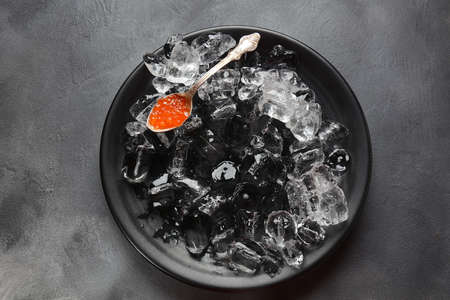 Delicious red caviar in a bowl with ice cubesの写真素材
