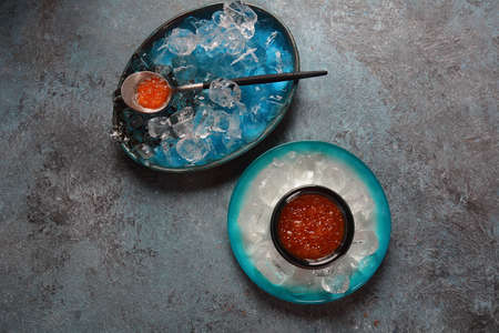 Delicious red caviar in a bowl with ice cubesの写真素材