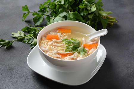 Chicken soup with noodles and vegetables in bowl. Healthy food concept