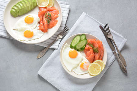 Healthy breakfast concept, fried eggs, avocado and smoked salmonの写真素材
