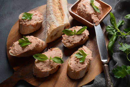 Chicken or goose liver pate sandwiches on a wooden boardの写真素材