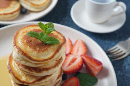 Sweet pancakes wrapped with fresh blueberries , mint, strawberries. Healthy breakfast concept