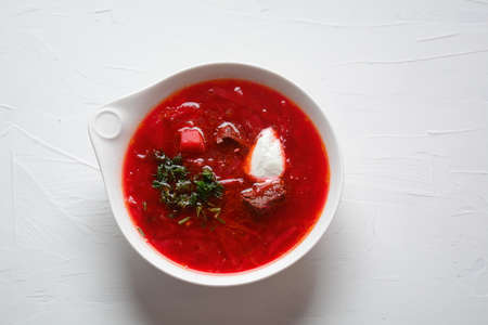 Traditional Ukrainian Russian borscht . Bowl of red beet root soup borsch with white cream . Beet...