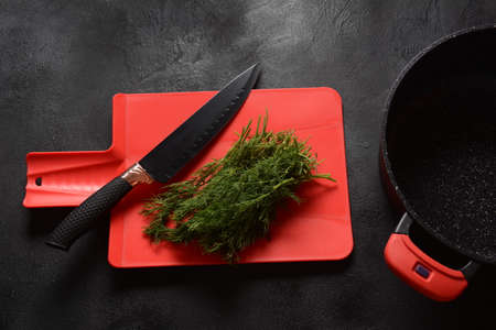 Fresh dill and knife on cutting board. Cooking, preparing food conceptの写真素材