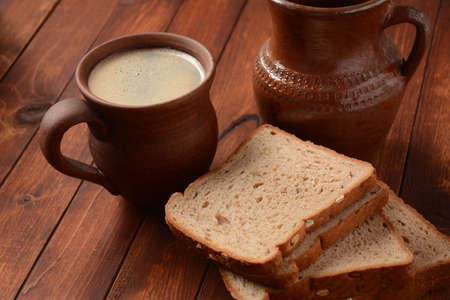 Traditional Russian or Ukrainian  Malt Beer -Kvass in  mug with rye bread on wooden table.