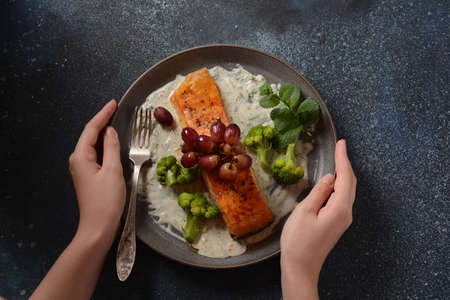 Grilled salmon with roasted red grapes and broccoli in creamy garlic sauce. Tuscan sea food recipe....