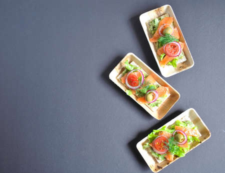 Healthy whole grain crispbread with avocado paste , salmon, olives, onion, tomatoes. Healthy...