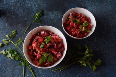 Vinegret or vinaigrette. Traditional Russian red salad with cooked and pickled vegetables, peas,...