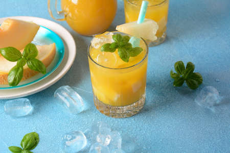 Refreshing drinks and citrus juices  with ice cubes, mint and melon. Summer conceptの写真素材