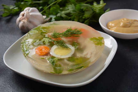 Home made aspic, jellied chicken meat with herbs and carrots. Traditional Russian dish holodets....
