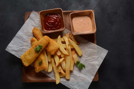 Traditional English Food - Fish and Chips. Fried fish filets and crispy French fries served with...