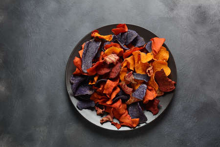 Baked vegetable chips- garnet sweet potato, purple sweet potato, carrot and beetroot. Gluten-free,...