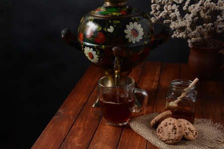 Tea Party in rustic style with samovar
a glass in glass holder, honey and cookies