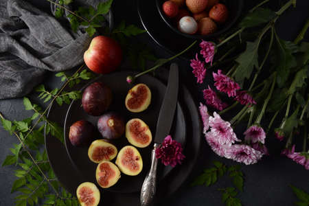 Raw fresh fig fruit slices with organic lychee fruit. Fresh lychee and peeled showing the red skin...