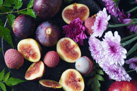 Raw fresh fig fruit slices with organic lychee fruit. Fresh lychee and peeled showing the red skin...