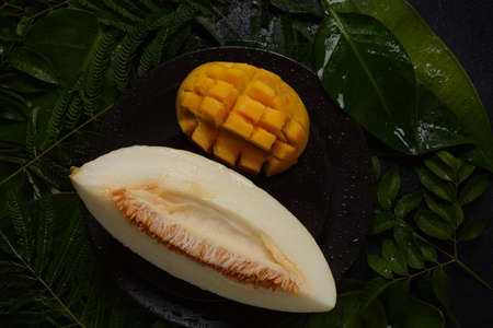 Melon slice on herb background. Sliced juicy piece of melon.