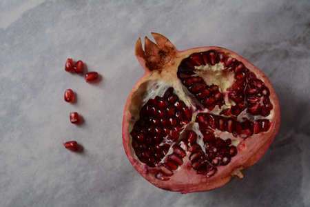 Fresh sliced pomegranates. Half pomegranate and pomegranate grainsの写真素材