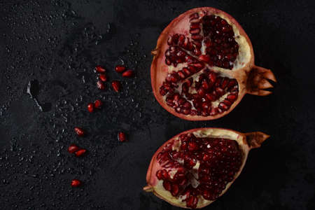Fresh sliced pomegranates. Half pomegranate and pomegranate grainsの写真素材