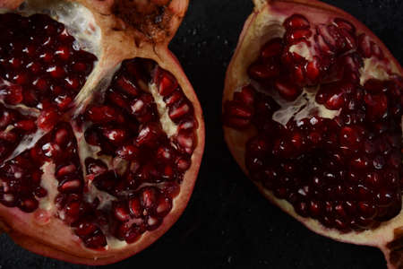 Fresh sliced pomegranates. Half pomegranate and pomegranate grainsの写真素材