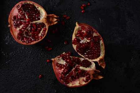 Fresh sliced pomegranates. Half pomegranate and pomegranate grainsの写真素材