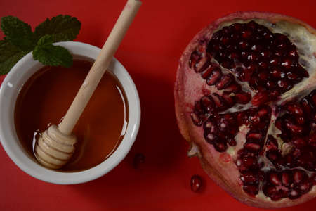 Honey jar, pomegranate, fresh apple. Rosh Hashanah (Jewish New Year holiday) concept.