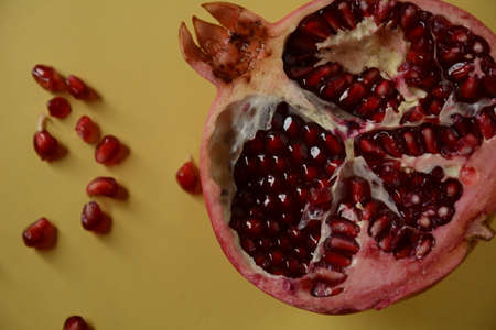 Fresh sliced pomegranates. Half pomegranate and pomegranate grainsの写真素材