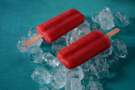 Strawberry popsicle on blue background