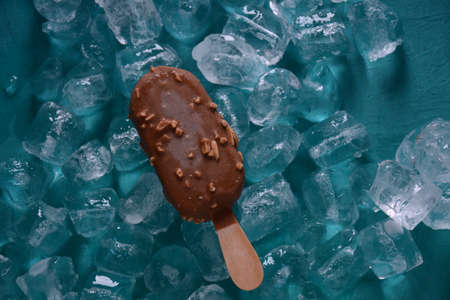 chocolate ice cream with almonds on ice cubes background