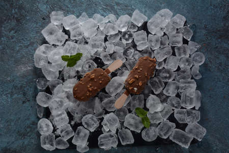 ice cream chocolate ice cream with almonds on ice cubes background