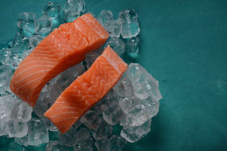Raw salmon steaks on ice backgroundの写真素材