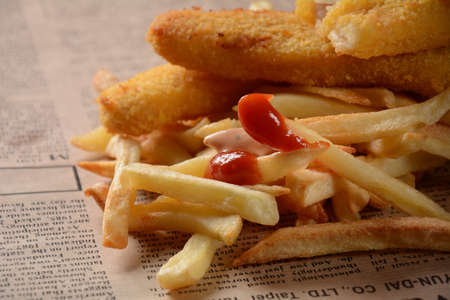 Traditional English Food - Fish and Chips. Fried fish filets and crispy French fries served with...