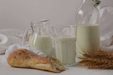 Baguette with milk on white background